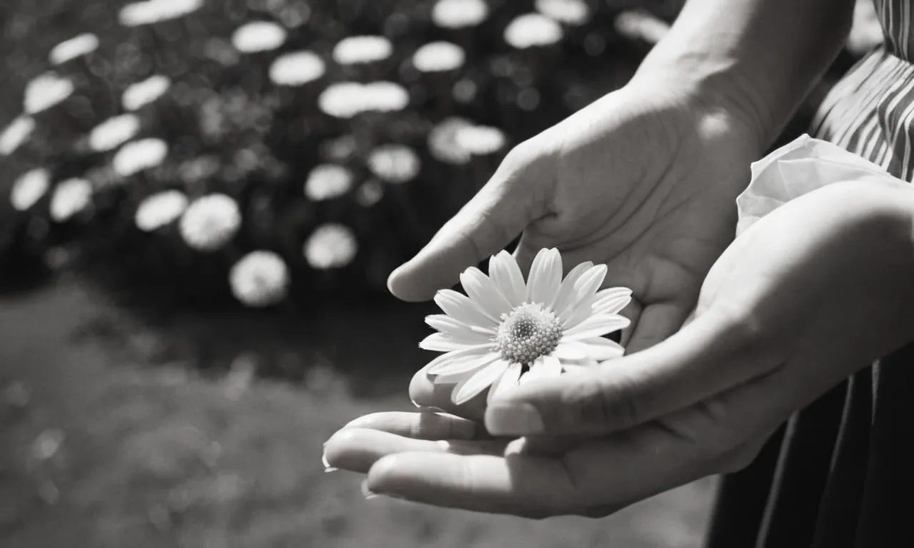 A black and white close-up image of a pair of hands, holding a delicate flower, capturing the sense of wonder and reverence towards nature, symbolizing the photographer's concept of God.