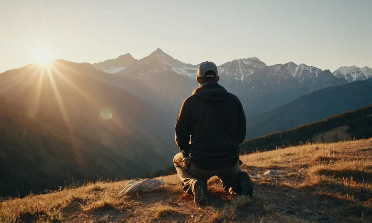 A photo capturing a peaceful sunrise over a majestic mountain range, with a person kneeling in prayer, symbolizing the pursuit of glorifying God and finding joy in His creation.