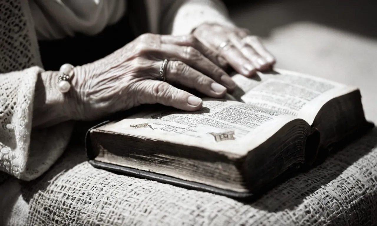 A black and white photograph capturing an aged woman's hands gently cradling a worn Bible, symbolizing Mary's grandmotherly love and spiritual influence on Jesus.
