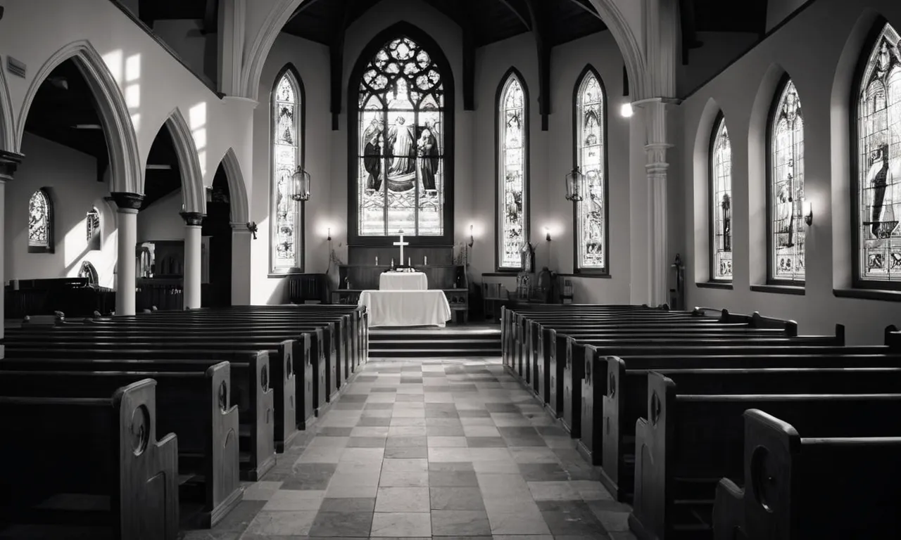A black and white photo capturing a solemn church interior, where a stained glass window of St. Jude stands tall, illuminating the space with a soft, ethereal glow.