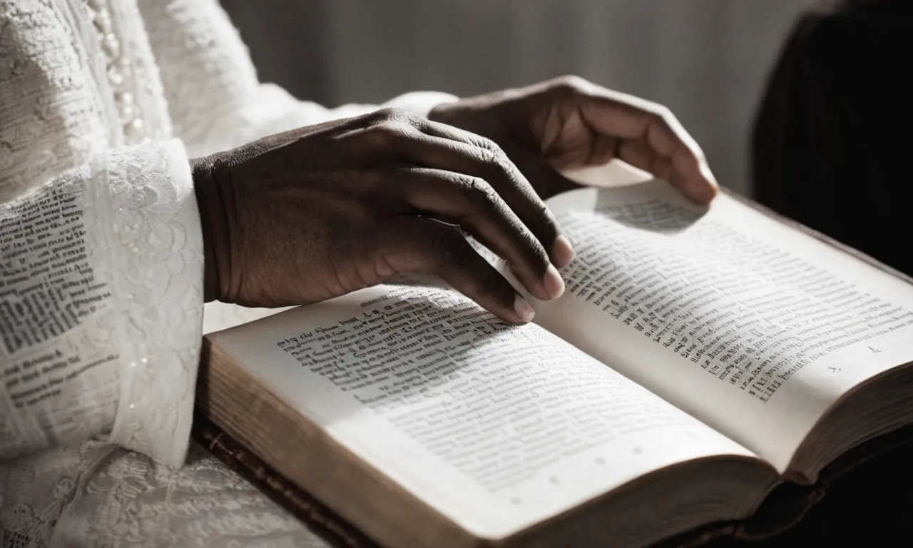 A black and white photograph capturing a pair of hands delicately holding an open Bible, bathed in soft light, emphasizing the verse "Who will go and redeem man" highlighted on the page.