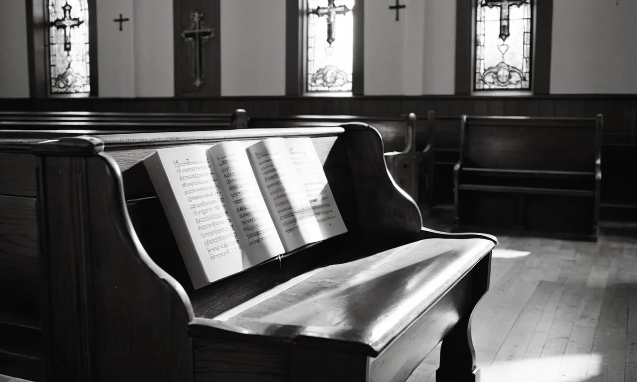 A black and white photograph capturing a humble church pew, bathed in soft light, as rays pierce through stained glass windows, illuminating a hymnal open to the page with the lyrics "I stand amazed."