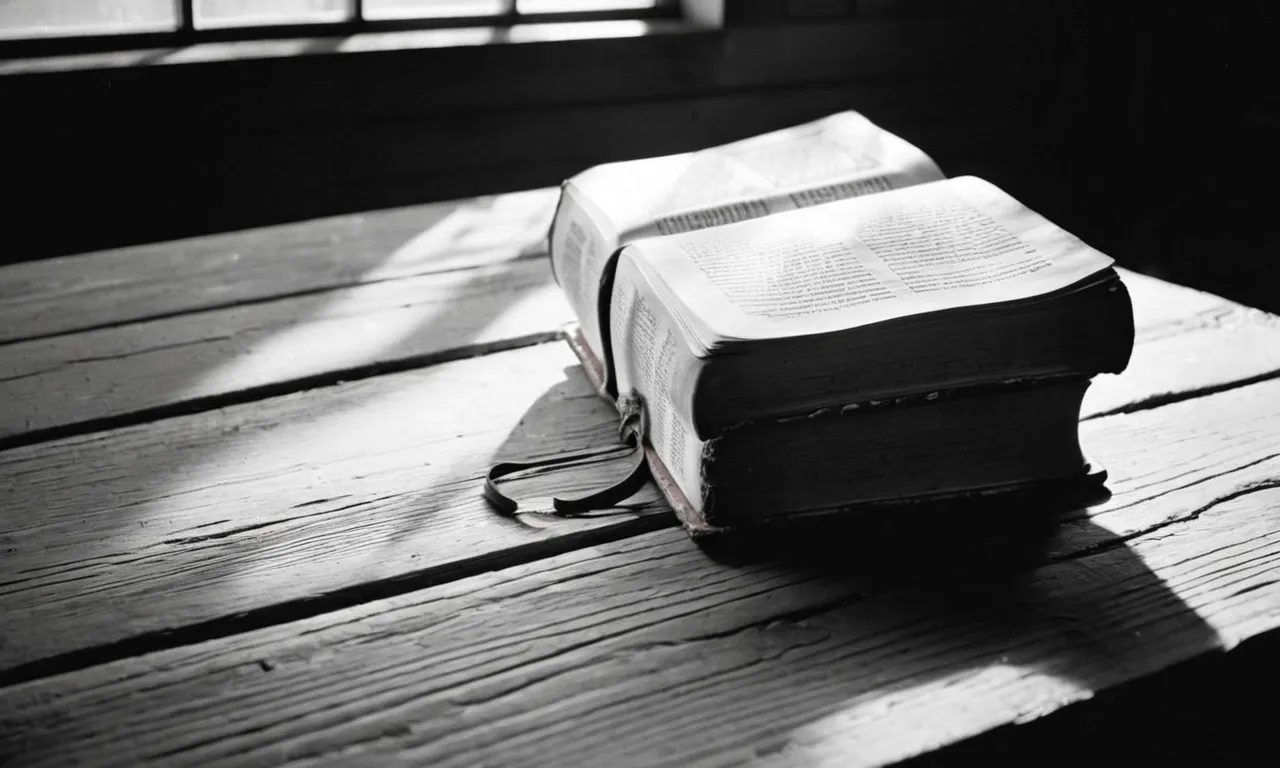 A black and white photo captures a weathered, open Bible resting on a wooden table, illuminated by a beam of sunlight streaming through a window, symbolizing the inspiration behind "Turn Your Eyes Upon Jesus."