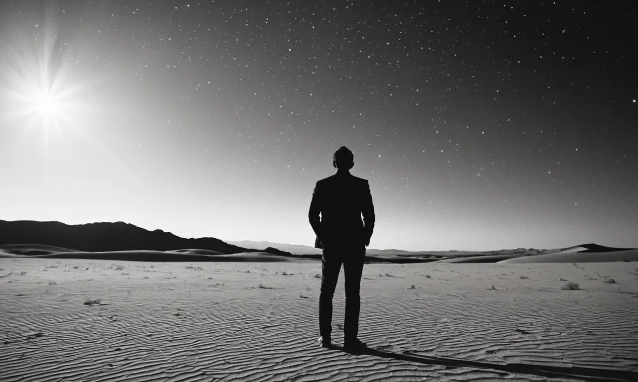 A black and white photo of a person standing alone in a vast desert, gazing up at a star-filled sky, capturing the existential pondering behind the question "why did god create atheists?"