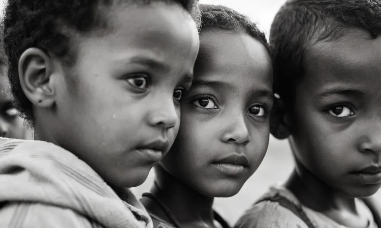 A powerful black and white image captures the resilience of Ethiopian children, their innocent eyes reflecting the hardships they face while questioning the divine reasons behind their nation's suffering.