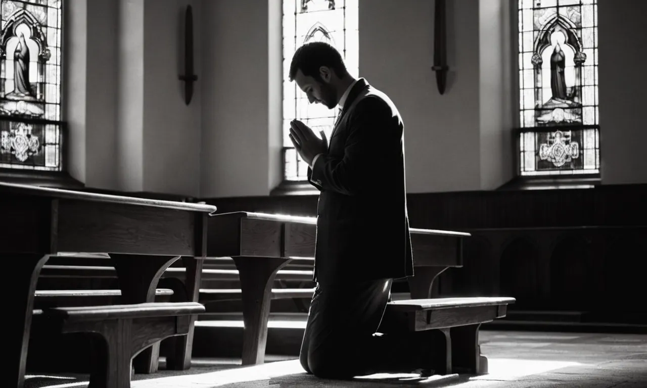 A black and white photograph captures a solitary figure kneeling in a dimly lit church, their hands clasped in prayer, as rays of light stream through stained glass windows, symbolizing faith and the enduring question of waiting for God's plans to unfold.