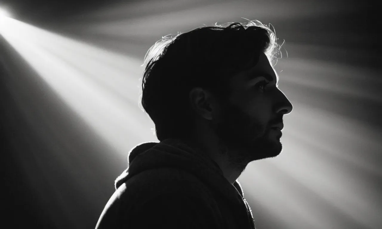 A black and white photograph captures a person gazing upwards, bathed in ethereal light, symbolizing the profound importance of a personal relationship with God.